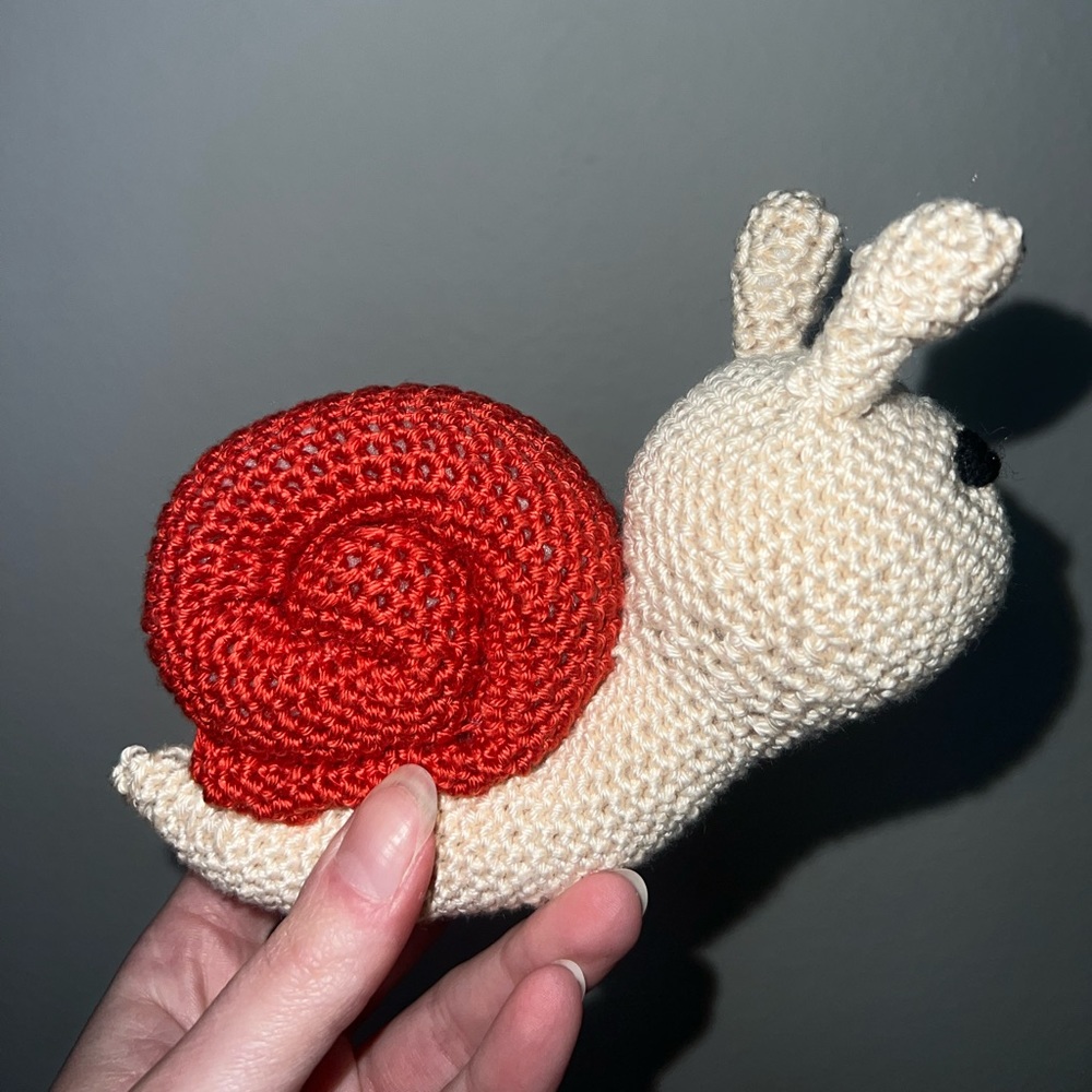 Hand a crocheted Sammy the Snail (Small)🐌 - Picture 4 of 7